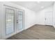 Bright room with white french doors and neutral-colored flooring at 1209 W Camellia Dr, Brandon, FL 33510