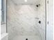 Modern shower with white marble-style tiling and sleek black fixtures at 1209 W Camellia Dr, Brandon, FL 33510