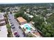 Aerial view of a neighborhood condo complex featuring a community pool, parking, and mature trees at 12760 Indian Rocks Rd # 579, Largo, FL 33774