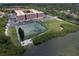 Aerial view of tennis courts, community building, and waterfront seating at 12760 Indian Rocks Rd # 579, Largo, FL 33774