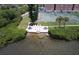 Aerial view of a lakefront deck with seating adjacent to a tennis court and residential building at 12760 Indian Rocks Rd # 579, Largo, FL 33774