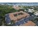 A beautiful aerial view of a condo complex with brick facade, mature landscaping, and ample parking near waterfront at 12760 Indian Rocks Rd # 579, Largo, FL 33774