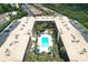 A bird's eye view of condo complex featuring a pool surrounded by palm trees in a serene courtyard at 12760 Indian Rocks Rd # 579, Largo, FL 33774