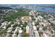 Aerial shot of a condo complex and neighborhood featuring water views, trees, and community pool at 12760 Indian Rocks Rd # 579, Largo, FL 33774