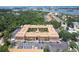 Aerial view showcases a condo complex with parking and a landscaped courtyard near a waterway with a coastal backdrop at 12760 Indian Rocks Rd # 579, Largo, FL 33774