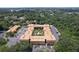Aerial view showcases a condo complex with a courtyard and parking bordered by mature trees in a residential neighborhood at 12760 Indian Rocks Rd # 579, Largo, FL 33774
