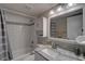 Bathroom featuring subway tile, granite countertop, and a shower with a gray curtain at 12760 Indian Rocks Rd # 579, Largo, FL 33774