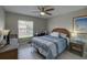 Bedroom with tile floors, ceiling fan, wicker furniture, and blue and white bedding at 12760 Indian Rocks Rd # 579, Largo, FL 33774