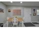 Bright dining area features a wooden table with seating and views of exterior at 12760 Indian Rocks Rd # 579, Largo, FL 33774