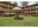 An outdoor seating area with table and benches is set in lush green lawn and surrounded by a well maintained property at 12760 Indian Rocks Rd # 579, Largo, FL 33774