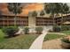 Beautiful condo with pool access, a white picket fence, and a walking path to the building at 12760 Indian Rocks Rd # 579, Largo, FL 33774