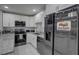 Well-lit kitchen boasts stainless steel appliances, granite countertops, white cabinets, and subway tile backsplash at 12760 Indian Rocks Rd # 579, Largo, FL 33774