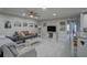 Open living area with ample seating, tile floors, and a view of the hallway at 12760 Indian Rocks Rd # 579, Largo, FL 33774