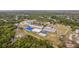 An aerial view of the community buildings, recreational areas, and surrounding greenery and landscape at 16113 Ternglade Dr, Lithia, FL 33547