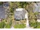 Stunning aerial view showcases the home's roof and the surrounding mature trees, nestled in a peaceful neighborhood at 16113 Ternglade Dr, Lithia, FL 33547