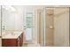 Modern bathroom featuring walk-in shower, granite vanity, and outdoor access, with stylish neutral tiles at 16113 Ternglade Dr, Lithia, FL 33547