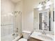 Bathroom with a shower-tub, marble countertop, and glass shower door at 16113 Ternglade Dr, Lithia, FL 33547