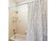 Cozy bathroom featuring a bathtub, shower head, and elegant curtain, offering a relaxing atmosphere at 16113 Ternglade Dr, Lithia, FL 33547