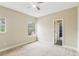 Bright bedroom with a ceiling fan, carpet floors, and natural light streaming in through two windows at 16113 Ternglade Dr, Lithia, FL 33547