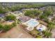 An aerial view of the community pool with splashpad, playground, grilling area and seating at 16113 Ternglade Dr, Lithia, FL 33547