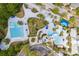 Top-down aerial showing the community pool and splashpad area, with sun loungers and umbrellas at 16113 Ternglade Dr, Lithia, FL 33547