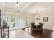 Elegant dining room with hardwood floors, chandelier, and large windows at 16113 Ternglade Dr, Lithia, FL 33547