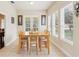 Bright dining room offers ample seating and serene views through large windows, perfect for Gathering meals at 16113 Ternglade Dr, Lithia, FL 33547