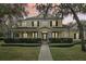 Charming two-story home with a welcoming front porch, lush greenery, and meticulously manicured landscaping at 16113 Ternglade Dr, Lithia, FL 33547