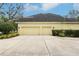 A two-car attached garage showcasing the home's ample parking space and exterior design at 16113 Ternglade Dr, Lithia, FL 33547
