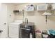 Functional laundry room with modern washer and dryer, storage shelves and ample space for organization at 16113 Ternglade Dr, Lithia, FL 33547