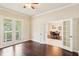 Bright living room featuring hardwood floors, french doors and an adjacent dining area for seamless entertaining at 16113 Ternglade Dr, Lithia, FL 33547