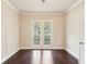Bright living room featuring hardwood floors and french doors leading to a balcony, perfect for relaxation at 16113 Ternglade Dr, Lithia, FL 33547