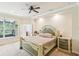 Serene main bedroom featuring a tray ceiling, fan, and a luxurious en-suite bathroom at 16113 Ternglade Dr, Lithia, FL 33547