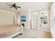 Bright, airy main bedroom offering a ceiling fan and access to a private screened patio, plus walk-in closet at 16113 Ternglade Dr, Lithia, FL 33547