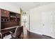 Home office space featuring a built-in desk, hardwood floors, and ample storage at 16113 Ternglade Dr, Lithia, FL 33547