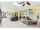 Enclosed patio boasting a hot tub, ceiling fans, comfortable seating, and a bright, airy atmosphere at 16113 Ternglade Dr, Lithia, FL 33547