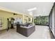 Enclosed patio featuring a hot tub, exercise equipment, screened in windows, and bright overhead lighting at 16113 Ternglade Dr, Lithia, FL 33547