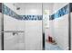 Spa-like bathroom showcasing custom tile work, glass shower door, and a shower bench at 1617 Oak Ne St, St Petersburg, FL 33704