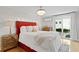 Primary bedroom with a red bed frame, a chandelier, and a door to an outdoor balcony at 1617 Oak Ne St, St Petersburg, FL 33704