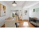 Bright dining area with wood floors, modern table setting, and access to the kitchen at 1617 Oak Ne St, St Petersburg, FL 33704