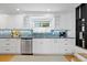 Updated kitchen features white cabinets, granite counters, and a stylish backsplash at 1617 Oak Ne St, St Petersburg, FL 33704