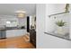 Updated kitchen with stainless appliances, light cabinets, hardwood floors, and modern lighting at 1617 Oak Ne St, St Petersburg, FL 33704