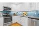Well-equipped kitchen with stainless steel appliances, granite countertops, and ample cabinetry at 1617 Oak Ne St, St Petersburg, FL 33704
