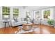 Bright living room featuring hardwood floors, large windows, and modern furniture at 1617 Oak Ne St, St Petersburg, FL 33704