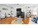 Bright living room with a fireplace, hardwood floors, and an open-concept layout at 1617 Oak Ne St, St Petersburg, FL 33704