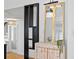 Stylish partition wall and gold framed mirror atop decorative cabinet in living area at 1617 Oak Ne St, St Petersburg, FL 33704