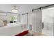 Bright bedroom with barn doors leading to an ensuite bathroom and view to the landscaped yard at 1617 Oak Ne St, St Petersburg, FL 33704