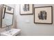 Chic powder room features a modern sink, vanity, and stylish artwork, creating an inviting space at 1797 Trailhead Ln, Zephyrhills, FL 33541