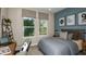 Cozy bedroom features a comfortable bed, a view of the outdoors, and stylish decor, ideal for relaxation and rest at 1797 Trailhead Ln, Zephyrhills, FL 33541