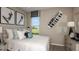 Cozy bedroom with a large window and unique wall decor, offering a personal and relaxing space at 1797 Trailhead Ln, Zephyrhills, FL 33541